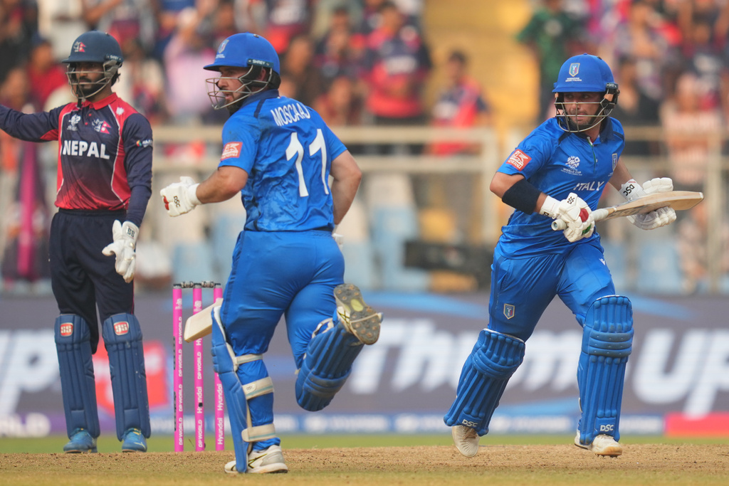 Italy's Anthony Mosca, left, Justin Mosca, right, run between the wickets as they bat during the T20 World Cup cricket match between Italy and Nepal in Mumbai, India, Thursday, Feb. 12, 2026. (AP Photo/Rafiq Maqbool)