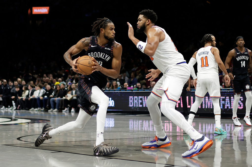Brooklyn Nets center Nic Claxton drives to the basket past New York Knicks center Karl-Anthony Towns during the second half of an NBA basketball game, Monday, Nov. 24, 2025, in New York. (AP Photo/Adam Hunger)