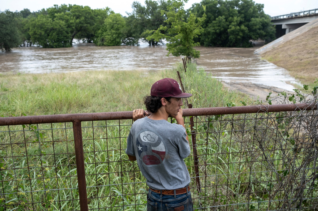 Hugh Ghormley watches as water moves along the Pedernales River at the Blanco County Fair and Rodeo on Thursday, July 16, 2026, in Johnson City, Texas. (AP Photo/Joel Angel Juarez)