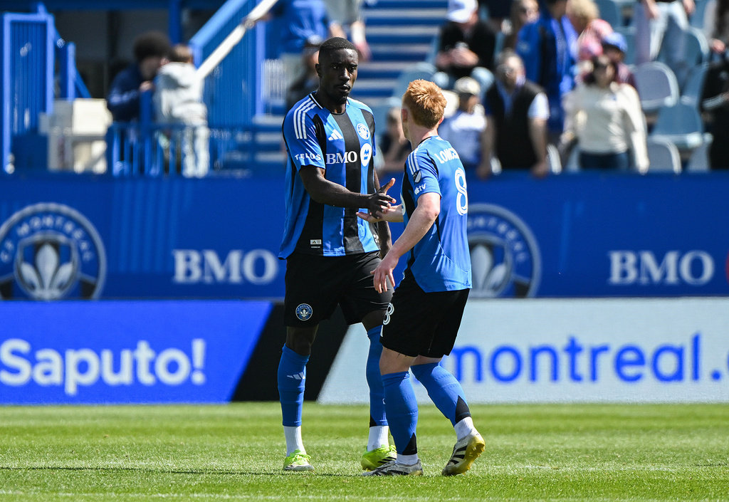 CF Montreal's Prince Owusu, left, celebrates with teammate Matty Longstaff (8) after scoring against New York City FC during the first half of a MLS soccer game in Montreal, Saturday, April 25, 2026.(Graham Hughes/The Canadian Press via AP)