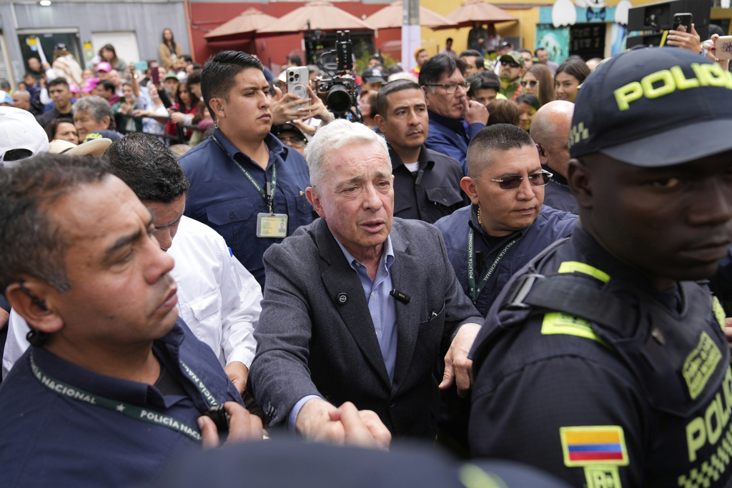 Former Colombian President Alvaro Uribe arrives to visit the site where presidential hopeful and Sen. Miguel Uribe Turbay was fatally shot during a political rally in Bogota, Colombia, Saturday, Aug. 23, 2025. (AP Photo/Fernando Vergara)