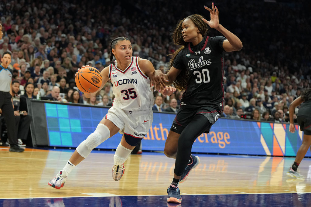 UConn guard Azzi Fudd (35) drives against South Carolina forward Maryam Dauda (30) during the first half of a woman's NCAA college basketball tournament semifinal game at the Final Four, Friday, April 3, 2026, in Phoenix. (AP Photo/Rick Scuteri)