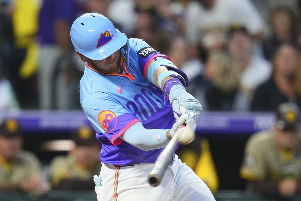 Colorado Rockies' Hunter Goodman hits a solo home run against the San Diego Padres during the third inning of a baseball game Friday, Sept. 5, 2025, in Denver. (AP Photo/Jack Dempsey)