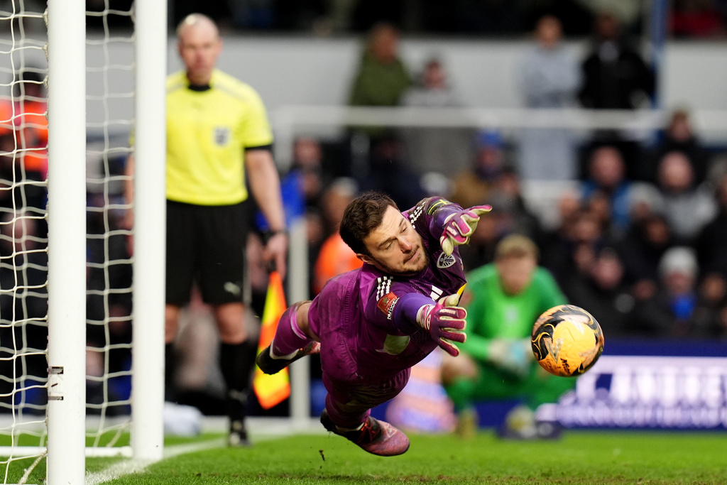 Leeds United goalkeeper Lucas Perri saves the penalty of Birmingham City's Tommy Doyle, not pictured, during the penalty shoot out at the end of the Emirates FA Cup fourth round match between Leeds United and Bimingham City, in Birmingham, England, Sunday Feb. 15, 2026. (Jacob King/PA via AP)