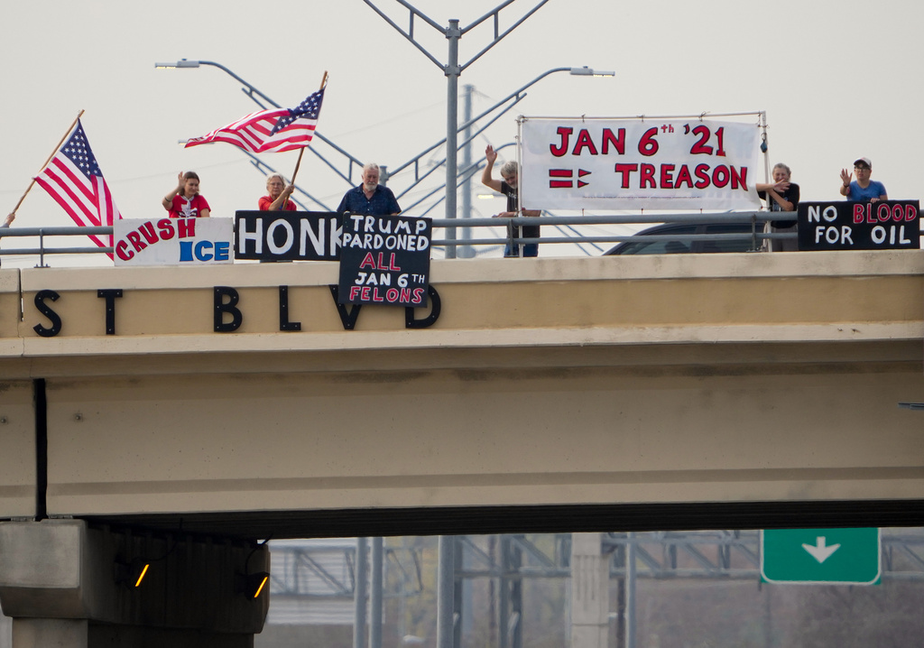 Members of Indivisible Rosedale Huddle protest the Jan. 6, 2021, attack on the U.S. Capitol on the Far West Boulevard overpass above MoPac Expressway in Austin, Texas, on the fifth anniversary of the attack, Tuesday, Jan. 6, 2026. From left are Gigs Hodges, Annie Compton, Greg Pierce, Frank Feuerbacher, Georgia Keysor and Jessica Frick. "We need to be reminded of those events and what they meant," Compton said. "And try for never again." (Jay Janner/Austin American-Statesman via AP)
