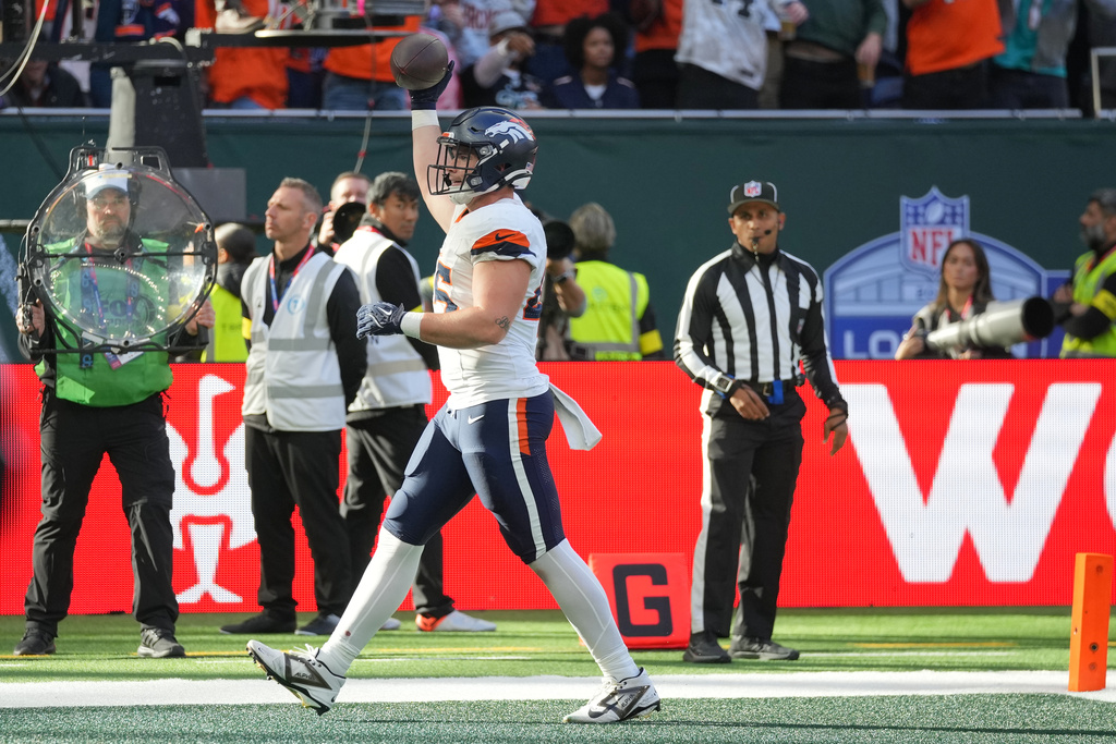 Denver Broncos tight end Nate Adkins (45) celebrates after scoring a touchdown in the first half of an NFL football game between the Denver Broncos and the New York Jets, Sunday, Oct. 12, 2025, in London. (AP Photo/Kin Cheung)