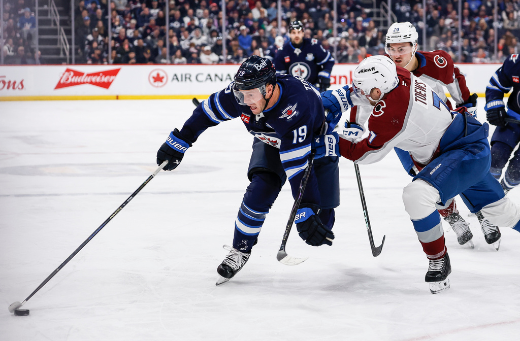 Colorado Avalanche's Devon Toews (7) defends against Winnipeg Jets' Jonathan Toews (19) during the second period of an NHL hockey game, in Winnipeg, Manitoba, Thursday, March 26, 2026. (John Woods/The Canadian Press via AP)