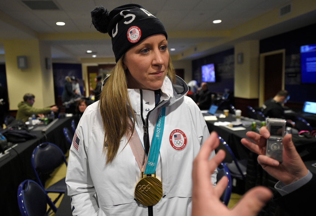 FILE - Meghan Duggan listens to a question from the media, March 3, 2018, in Annapolis, Md. (AP Photo/Nick Wass, File)