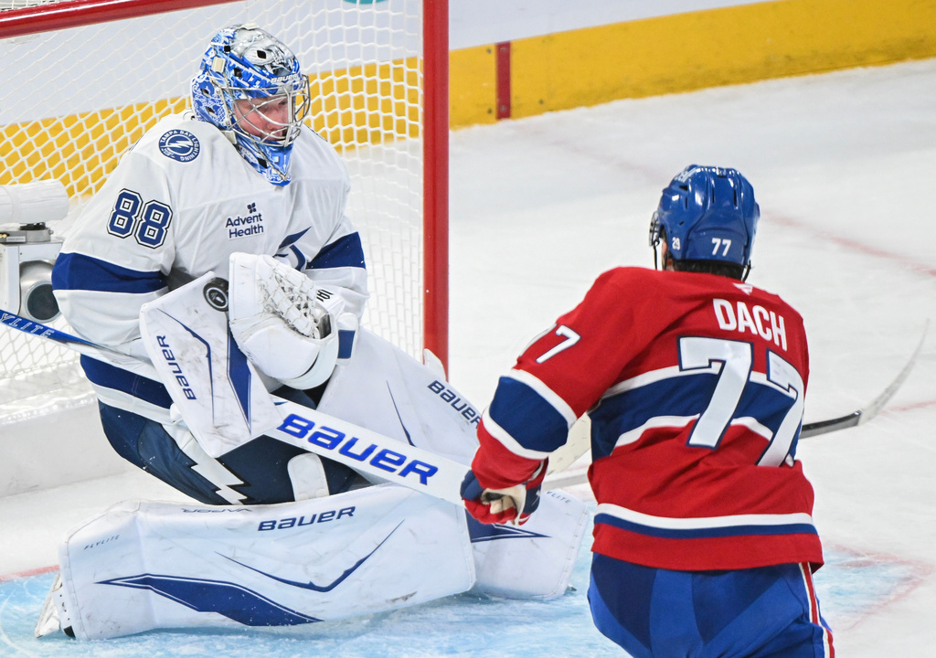 Tampa Bay Lightning goaltender Andrei Vasilevskiy (88) makes a save against Montreal Canadiens' Kirby Dach (77) during the second period of Game 3 in a first-round NHL hockey Stanley Cup playoff series in Montreal, Friday, April 24, 2026. (Graham Hughes/The Canadian Press via AP)