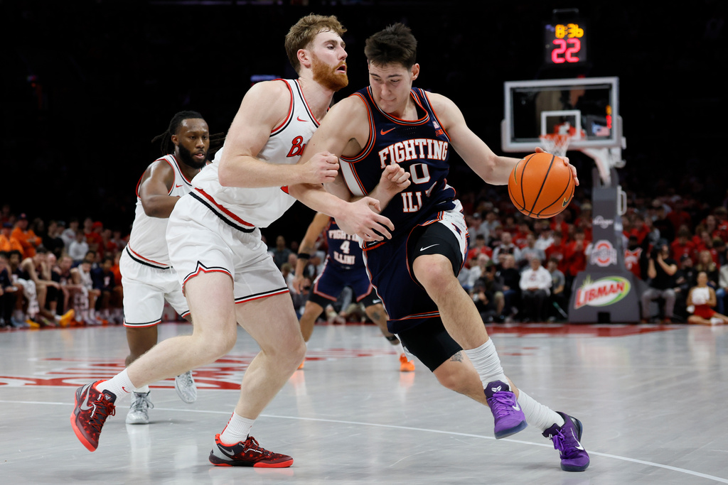 Illinois' David Mirkovic, right, drives to the basket as Ohio State's Brandon Noel defends during the first half of an NCAA college basketball game, Tuesday, Dec. 9, 2025, in Columbus, Ohio. (AP Photo/Jay LaPrete)