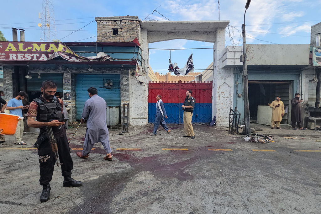 Police officers examine the site following a suicide bombing, in Kabal, a town in the Swat Valley in Pakistan's Khyber Pakhtunkhwa province, Sunday, Aug. 2, 2026. (AP Photo/Sherin Zada)