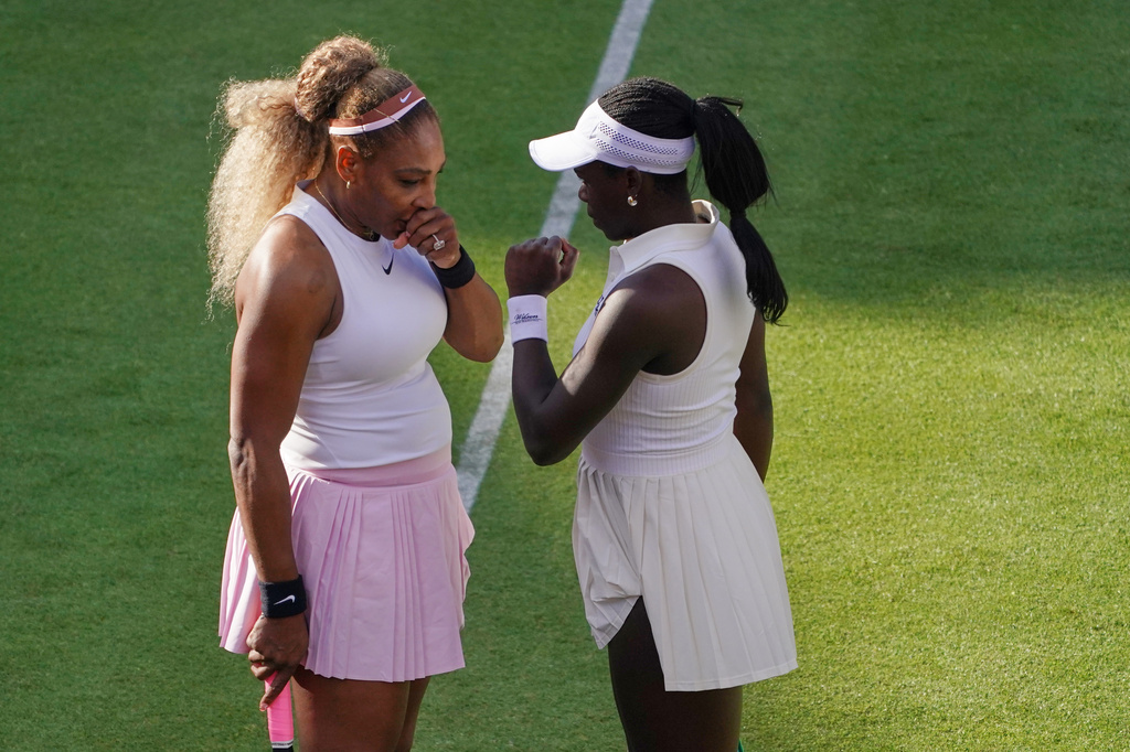 Serena Williams of the United States, left, talks to playing partner Victoria Mboko of Canada as they play against Nicole Melichar-Martinez of Canada and Erin Routliffe of New Zealand during their first round doubles match at the Queen's Club tennis championships in London, Tuesday, June 9, 2026. (AP Photo/Alberto Pezzali)