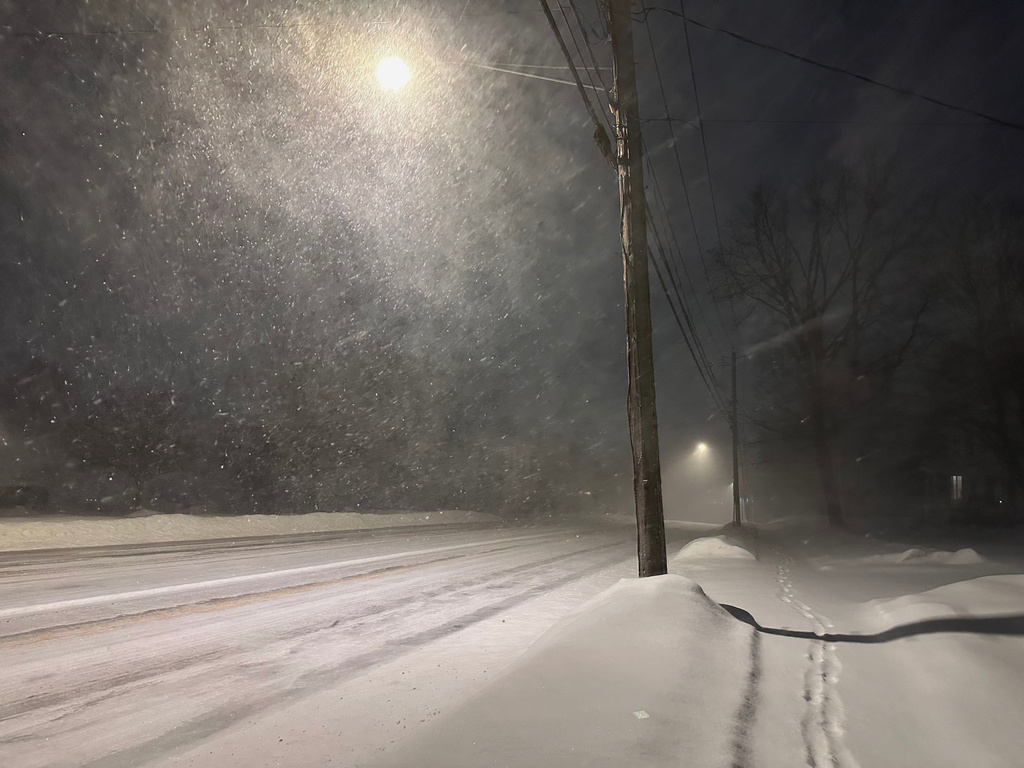 Fresh snow blows through Lowville, New York, Monday, Dec. 29, 2025, as parts of the Great Lakes region and Northeast are under a winter storm warning. (AP Photo/Cara Anna)