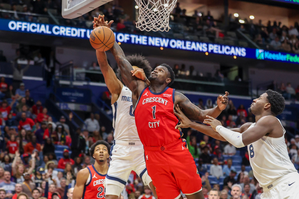 Memphis Grizzlies forward Jaylen Wells and New Orleans Pelicans forward Zion Williamson (1) go after the ball in the first half of an Emirates NBA Cup basketball game, Wednesday, Nov. 26, 2025, in New Orleans. (AP Photo/Peter Forest)