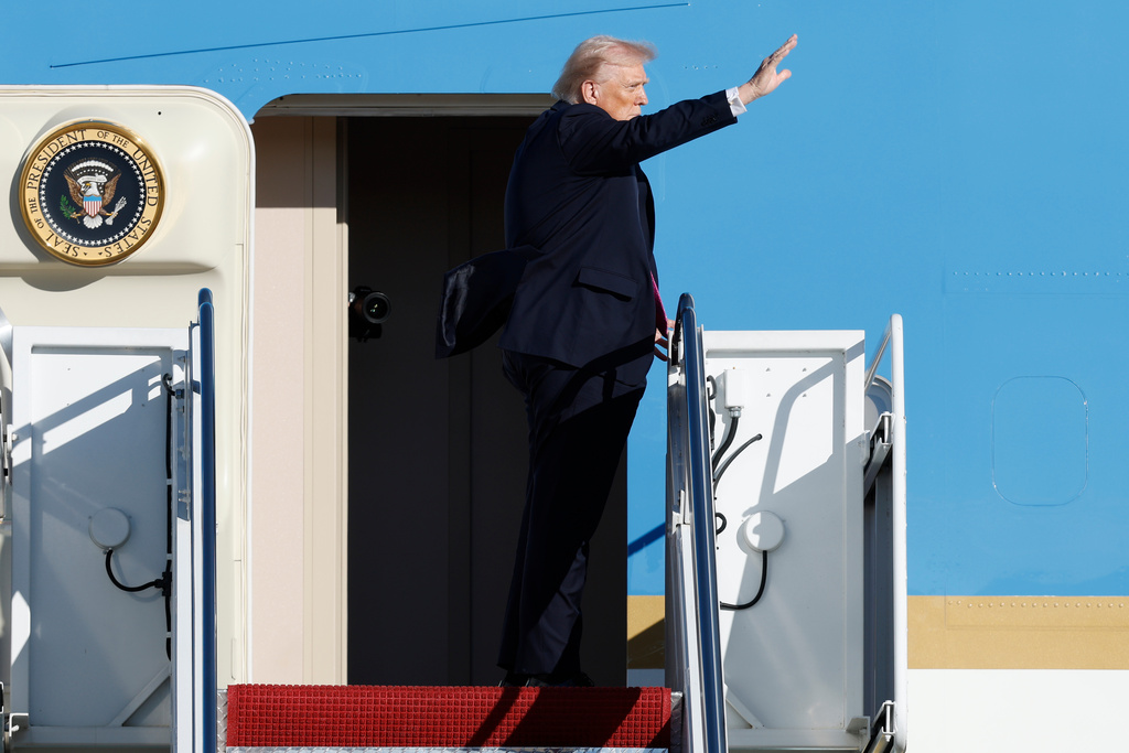 President Donald Trump waves from the stairs of Air Force One as he boards upon his arrival at Joint Base Andrews, Md., Friday, Oct. 17, 2025. (AP Photo/Luis M. Alvarez)