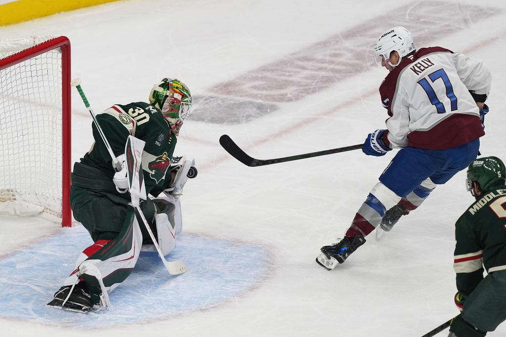 Minnesota Wild goaltender Jesper Wallstedt (30) blocks a shot by Colorado Avalanche center Parker Kelly (17) during the first period of Game 3 of an NHL Stanley Cup hockey second-round playoff series Saturday, May 9, 2026, in St. Paul, Minn. (AP Photo/Abbie Parr)