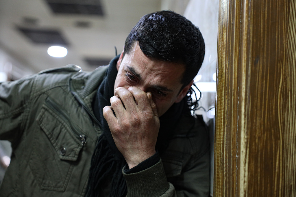 Syrian man Mohammed Ajam, weeps at a hospital after his son, Ghaith, 4, died after clashes broke out between Syrian government forces and Kurdish fighters in a contested area of the northern city of Aleppo, Syria, Tuesday, Jan. 6, 2026. (AP Photo/Omar Albam)