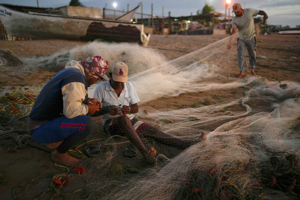 Fishermen ready their nets near the Cardon refinery in Punta Cardon, Venezuela, Wednesday, Jan. 14, 2026. (AP Photo/Matias Delacroix)