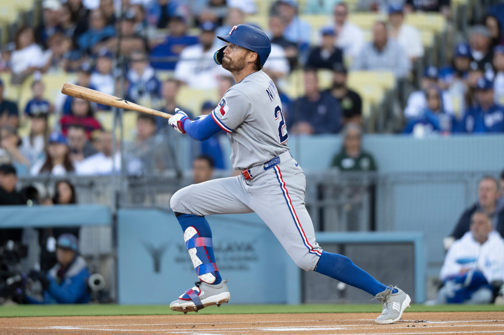 Texas Rangers' Brandon Nimmo watches his solo home run during the first inning of a baseball game against the Los Angeles Dodgers in Los Angeles, Saturday, April 11, 2026. (AP Photo/Kyusung Gong)