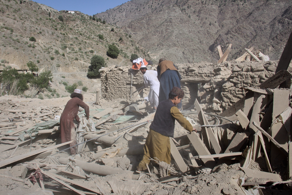 Residents go through the rubble after what Taliban officials said was airstrikes carried out by Pakistan, and killed civilians, including children, in Mana, a village in Afghanistan's Khost province, Wednesday, June 10, 2026. (AP Photo/Saifullah Zahir)