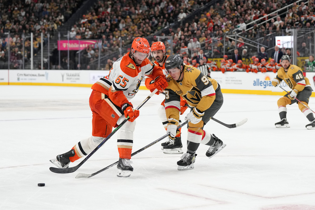 Anaheim Ducks defenseman Jacob Trouba (65) steals the puck from Vegas Golden Knights right wing Mitch Marner (93) in the second period of an NHL hockey game Saturday, Nov. 8, 2025, in Las Vegas. (AP Photo/Candice Ward)