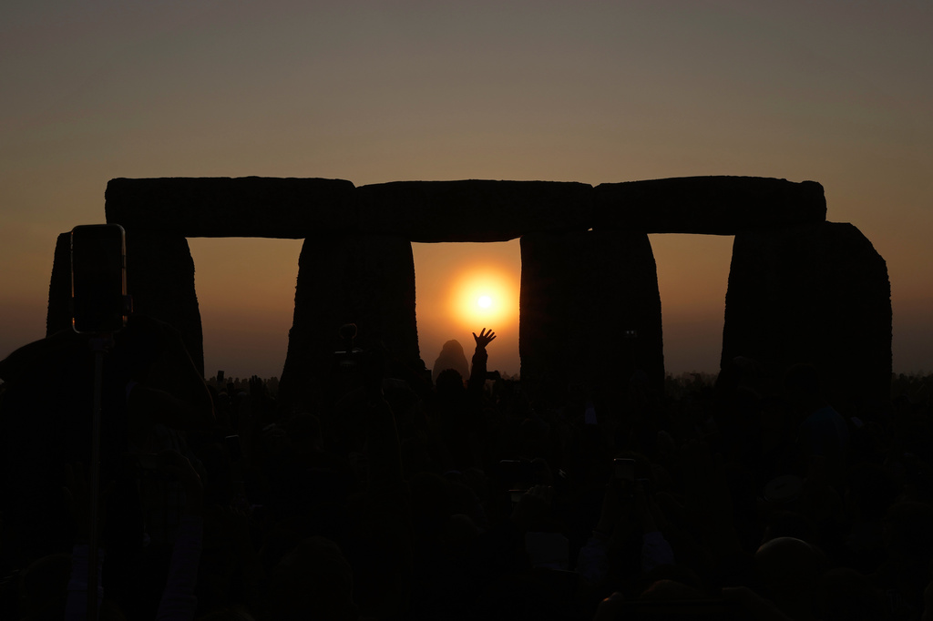 FILE - Revelers gather at the ancient stone circle Stonehenge to celebrate the Summer Solstice, the longest day of the year, near Salisbury, England, Wednesday, June 21, 2023. (AP Photo/Kin Cheung, File)