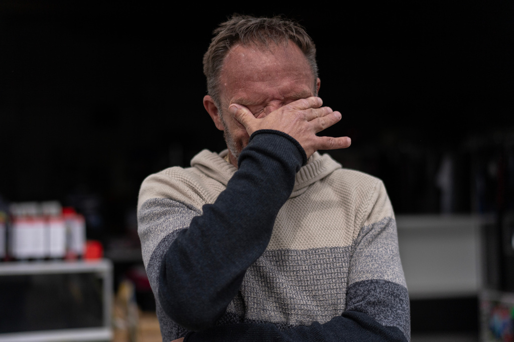 Anthony Crihfield Jones wipes tears outside his JCD Bargain and Trade store near Ripley, W.Va., Friday, March 13, 2026, as he closed his other nearby location to consolidate his businesses under one roof due to high electric bills. (AP Photo/Carolyn Kaster)