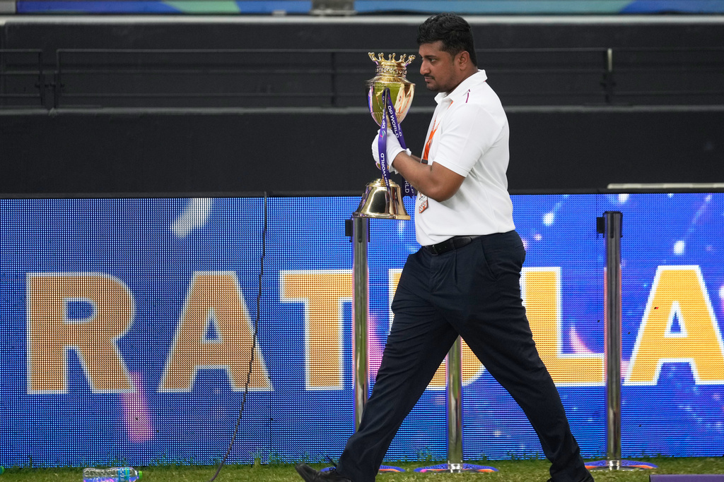 An official removes the winners' trophy from the presentation area after India won the Asia Cup cricket final against Pakistan at Dubai International Cricket Stadium, United Arab Emirates, Sunday, Sept. 28, 2025. (AP Photo/Altaf Qadri)
