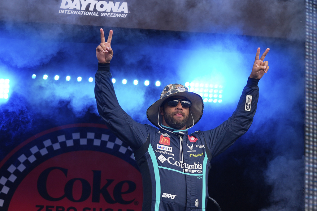Bubba Wallace waves to fans during driver introductions before the NASCAR Cup Series auto race at Daytona International Speedway, Aug. 23, 2025, in Daytona Beach, Fla. (AP Photo/John Raoux)