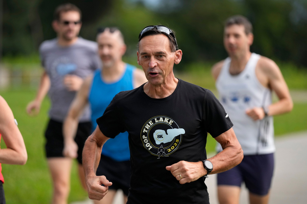 Paul Grinvalds, of West Des Moines, Iowa, runs with the Raccoon River Running Club, Sunday, Aug. 9, 2026, in West Des Moines, Iowa. (AP Photo/Charlie Neibergall)