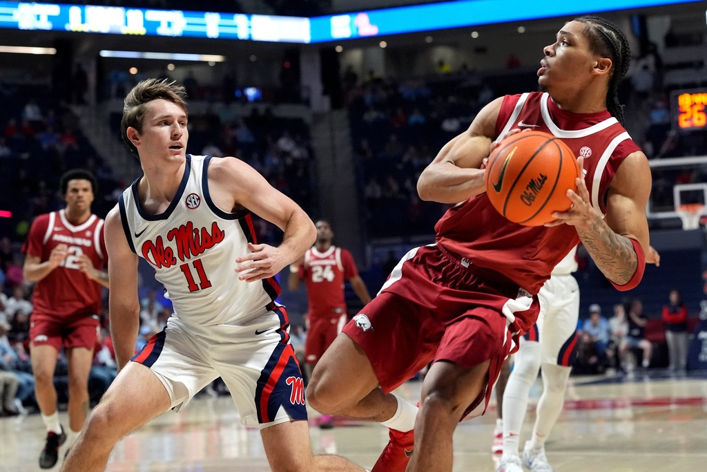 Arkansas guard Darius Acuff Jr. (5) steps back to take a shot at the basket while guarded by Mississippi guard Travis Perry (11) during the first half of an NCAA college basketball game, Wednesday, Jan. 7, 2026, in Oxford, Miss. (AP Photo/Rogelio V. Solis)