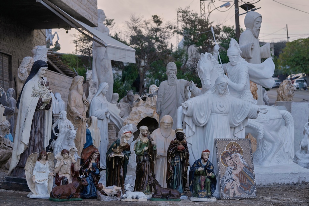 Religious statues and nativity figures are displayed for sale outside a workshop in the northeast mountain town of Kousba, Lebanon, Saturday, Nov. 15, 2025. (AP Photo/Hassan Ammar)