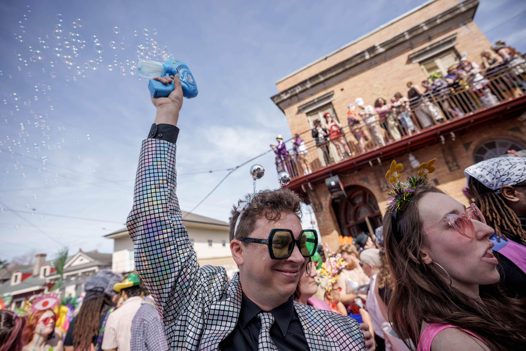 People participating in the Society of Saint Anne parade wander through the Bywater and Marigny neighborhoods on Mardi Gras Day, Tuesday, Feb. 17, 2026 in New Orleans. (AP Photo/Matthew Hinton)