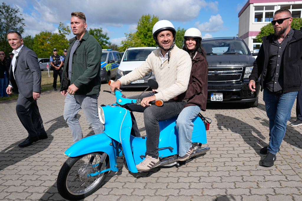 Ulrich Siegmund, top candidate for the "Alternative for Germany" (AfD) party and his wife Julia leaving a polling station on a small Schwalbe motorcycle after voting during the Saxony-Anhalt state elections in Tangermuende, eastern Germany, Sunday, Sept. 6, 2026. (AP Photo/Matthias Schrader)