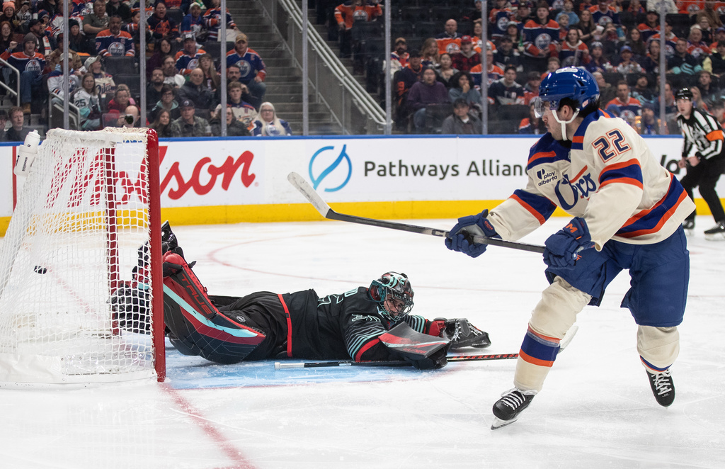 Seattle Kraken goalie Joey Daccord (35) is scored on by Edmonton Oilers' Matt Savoie (22) during second period NHL action, in Edmonton on Thursday, December 4, 2025. (Jason Franson/The Canadian Press via AP)
