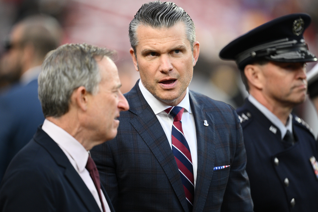 Defense Secretary Pete Hegseth is seen on the sidelines before an NFL football game between the Washington Commanders and the Detroit Lions Sunday, Nov. 9, 2025, in Landover, Md. (AP Photo/Nick Wass)