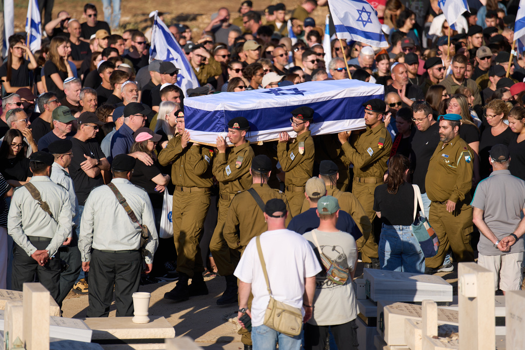 Israeli soldiers carry the casket of Staff sergeant Noam Hamburger, who was killed in a Lebanese drone attack on northern Israel, during his funeral in Atlit, Israel, Sunday, May 24, 2026. (AP Photo/Ariel Schalit)