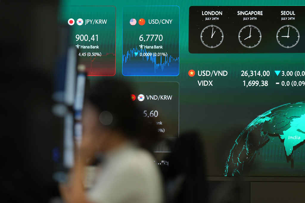 A dealer talks on the phone near the screens showing the foreign exchange rates at a dealing room of Hana Bank in Seoul, South Korea, Friday, July 24, 2026. (AP Photo/Lee Jin-man)
