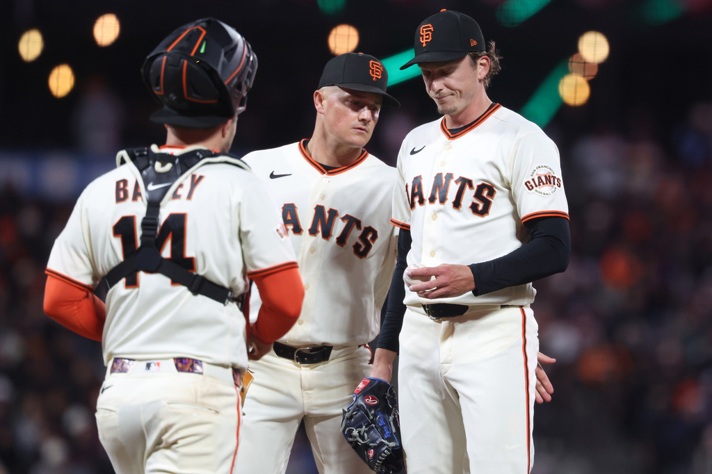 San Francisco Giants pitcher Ryan Borucki, right, talks with Matt Chapman, center, and Patrick Bailey (14) during the seventh inning of a baseball game against the Philadelphia Phillies in San Francisco, Monday, April 6, 2026. (AP Photo/Jed Jacobsohn)