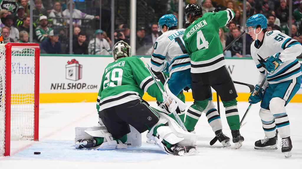 San Jose Sharks right wing Collin Graf (51) scores against Dallas Stars goaltender Jake Oettinger (29) and defenseman Miro Heiskanen (4) during the second period of an NHL hockey game Friday, Dec. 5, 2025, in Dallas. (AP Photo/LM Otero)