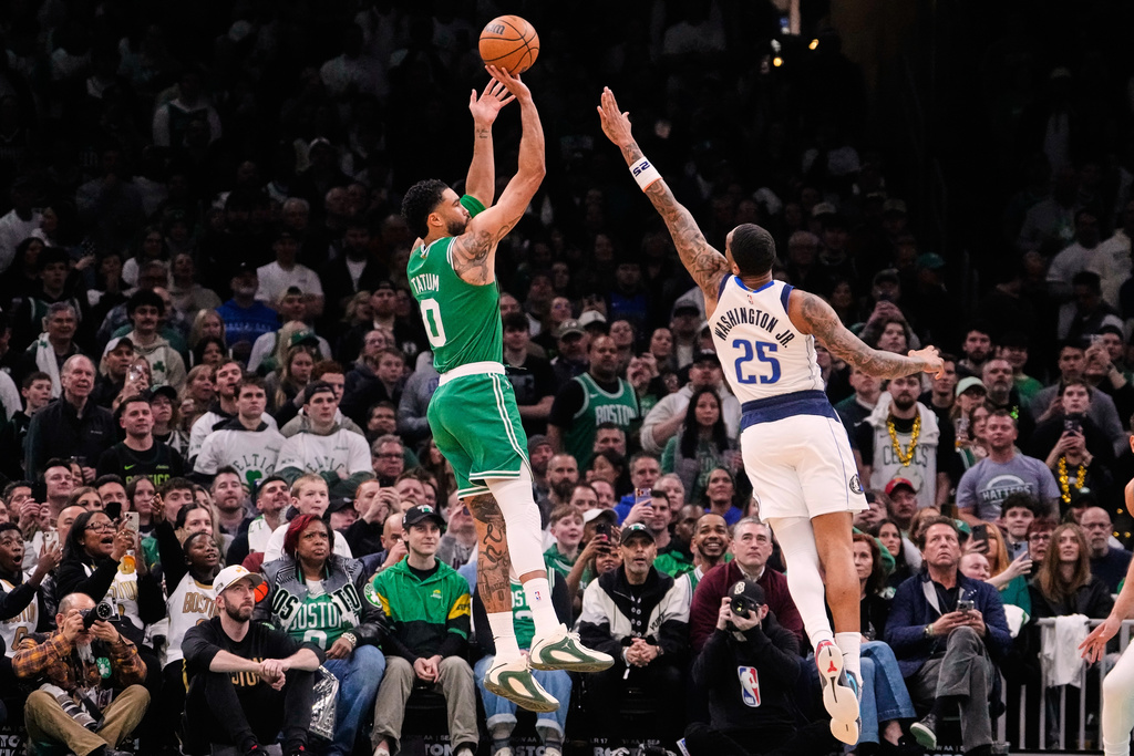 Boston Celtics forward Jayson Tatum (0) goes up to shoot over Dallas Mavericks forward P.J. Washington (25) during the first half of an NBA basketball game, Friday, March 6, 2026, in Boston. (AP Photo/Charles Krupa)