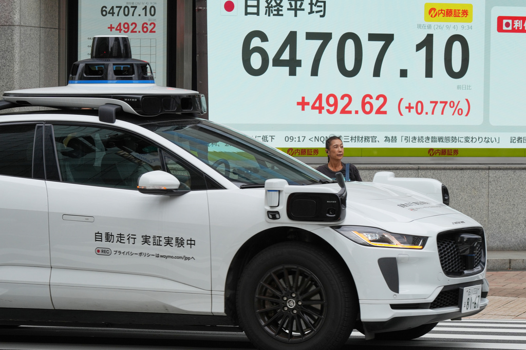 A person stands in front of an electronic stock board showing Japan's Nikkei index at a securities firm Friday, Sept. 4, 2026, in Tokyo. (AP Photo/Eugene Hoshiko)