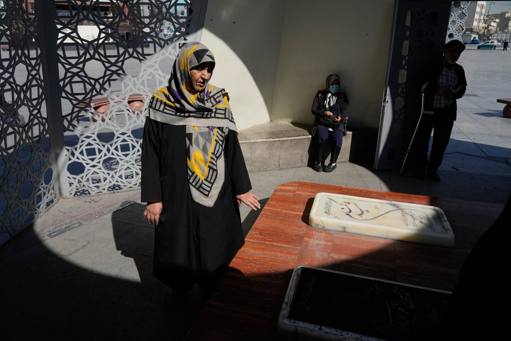 People pray at the graves of Iranian soldiers who were killed during 1980-88 Iraq-Iran war, in downtown Tehran, Iran, Tuesday, Feb. 17, 2026. (AP Photo/Vahid Salemi)