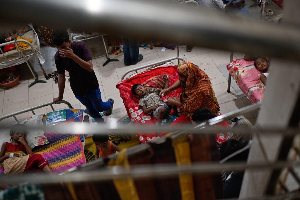 Patients receive treatment during a measles outbreak as family members sit beside them in an overcrowded hospital in Dhaka, Bangladesh, Tuesday, Sept. 8, 2026. (AP Photo/Mahmud Hossain Opu)