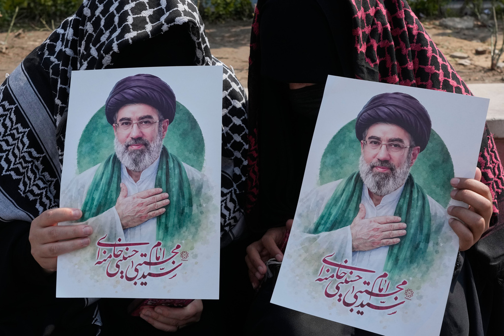Women hold posters of the Iranian Supreme Leader Ayatollah Mojtaba Khamenei during a campaign in support of the government at the Enqelab-e-Eslami, or Islamic Revolution, square in downtown Tehran, Iran, Saturday, March 14, 2026. (AP Photo/Vahid Salemi)