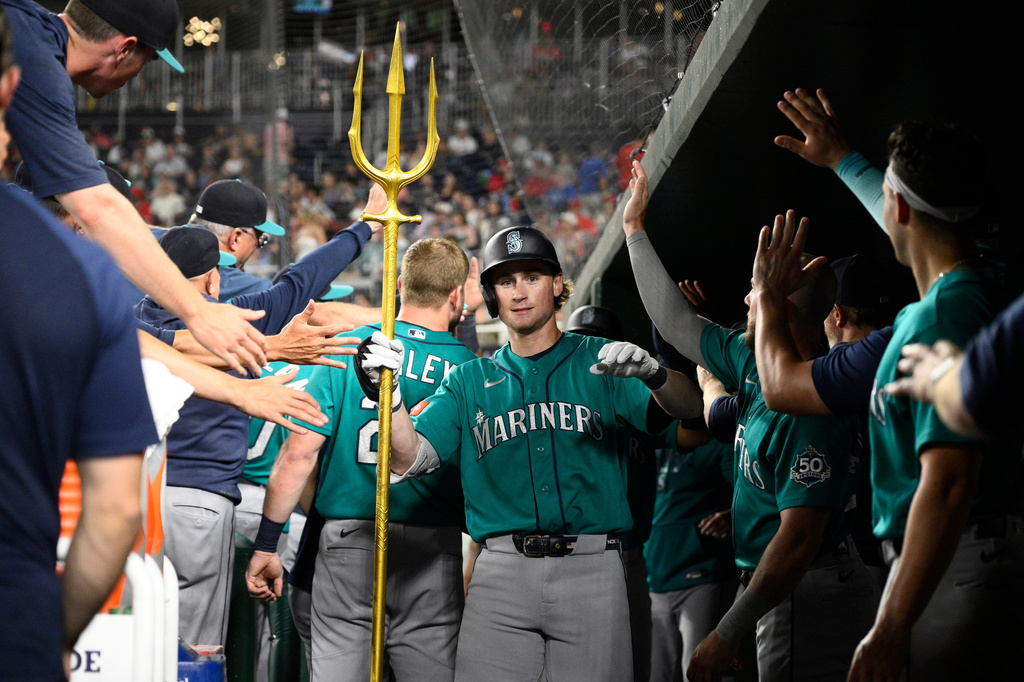 Seattle Mariners' Colt Emerson celebrates his two-run home run in the dugout during the second inning of a baseball game against the Washington Nationals, Friday, June 12, 2026, in Washington. (AP Photo/Nick Wass)