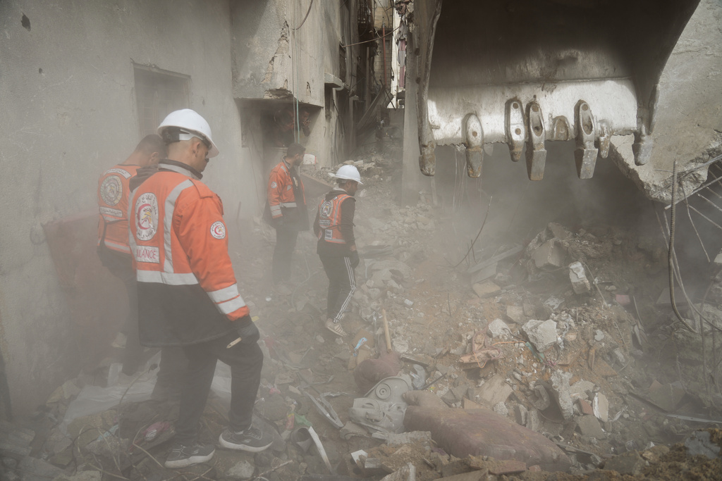 Gaza's civil defense teams work to recover the remains of members of the Abu Nada family, who remain trapped beneath the rubble of their four-story house after it was destroyed by an Israeli airstrike in December 2023, in Gaza City, Monday, Feb. 9, 2026. (AP Photo/Jehad Alshrafi)