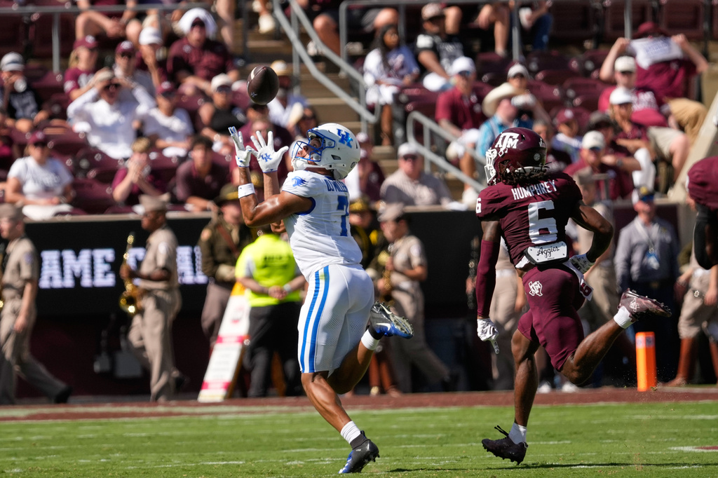 Kentucky wide receiver DJ Miller (7) catches a pass for a first down as Texas A&M cornerback Julio Humphrey (6) defends during the first half of an NCAA college football game Saturday, Sept. 19, 2026, in College Station, Texas. (AP Photo/David J. Phillip)