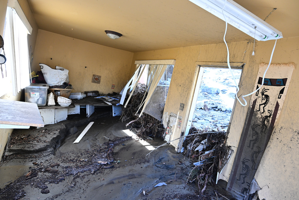 Mud covers the inside of a property after a series of storms on Thursday, Dec. 25, 2025, in Wrightwood, Calif. (AP Photo/William Liang)