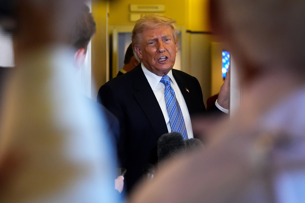 President Donald Trump speaks to reporters aboard Air Force One, Friday, May 15, 2026, as he returns from a trip to Beijing, China. (AP Photo/Mark Schiefelbein)